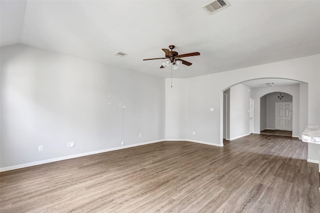 spare room featuring hardwood / wood-style floors, ceiling fan, and lofted ceiling