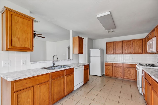 kitchen with ceiling fan, sink, tasteful backsplash, white appliances, and light tile patterned floors