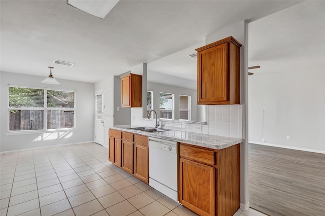 kitchen featuring pendant lighting, white dishwasher, sink, ceiling fan, and light tile patterned floors