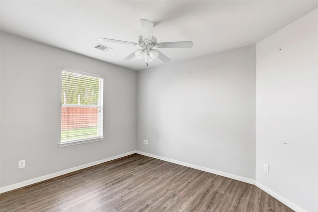 spare room featuring hardwood / wood-style floors and ceiling fan