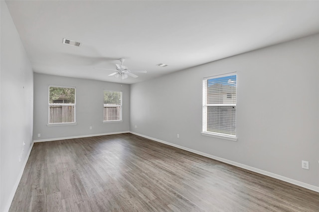 empty room featuring hardwood / wood-style flooring and ceiling fan