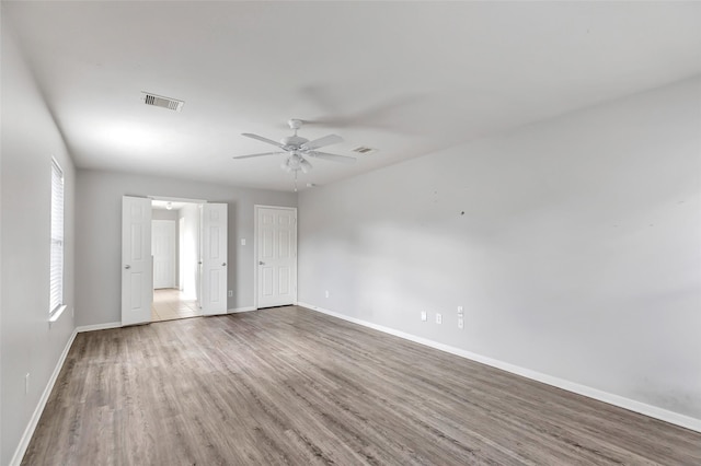 spare room featuring ceiling fan and hardwood / wood-style floors