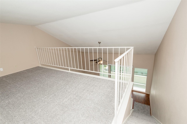 staircase featuring carpet floors and vaulted ceiling