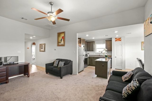 carpeted living room featuring ceiling fan