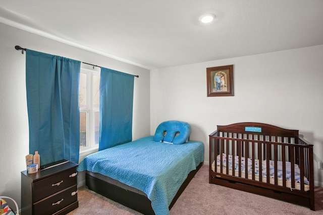 bedroom featuring light carpet