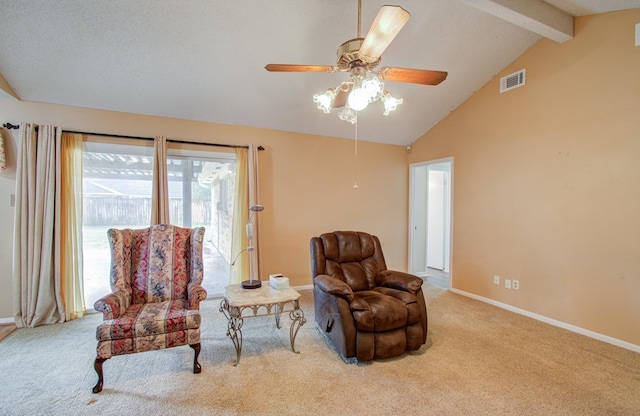 living area featuring ceiling fan, light colored carpet, and lofted ceiling with beams