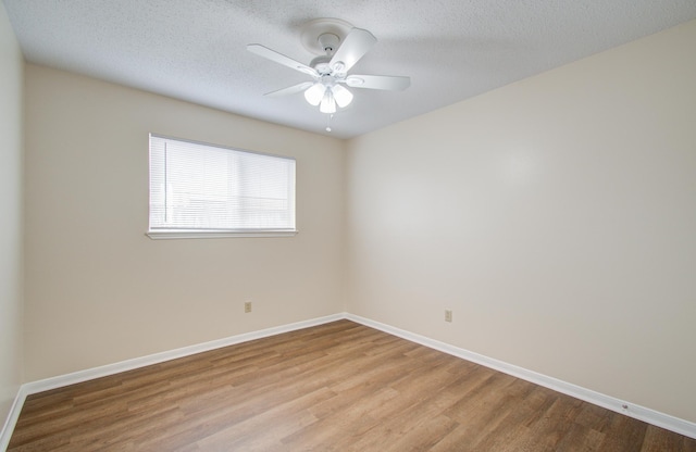 empty room with a textured ceiling, light hardwood / wood-style flooring, and ceiling fan