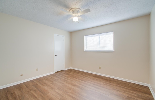 spare room with ceiling fan, light hardwood / wood-style floors, and a textured ceiling