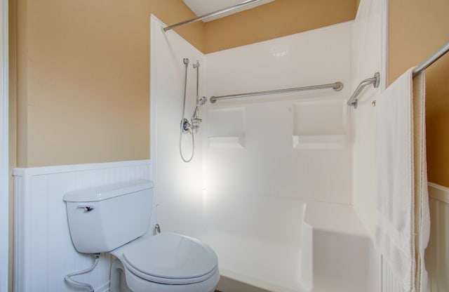 bathroom with toilet and walk in shower