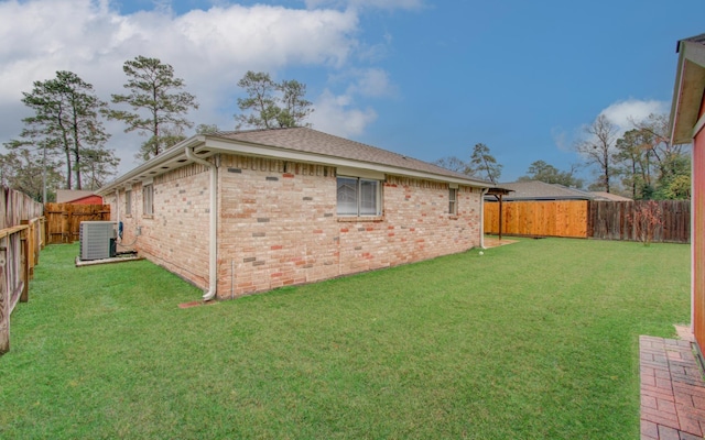 exterior space with a lawn and central AC