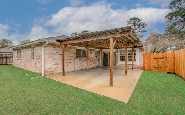 back of property with a pergola, a patio area, and a yard