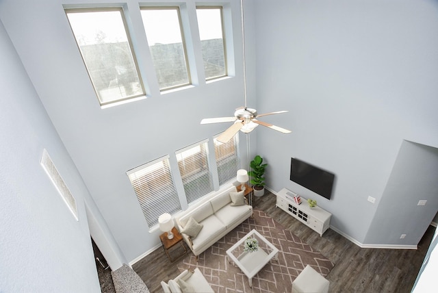 living room with ceiling fan and dark hardwood / wood-style flooring