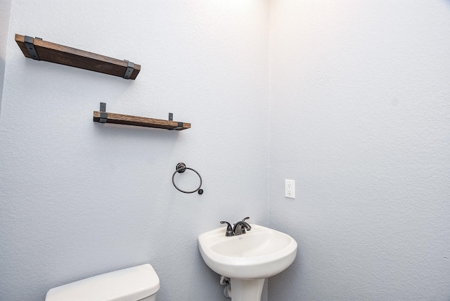 bathroom with toilet and sink