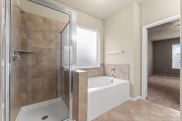 bathroom with tile patterned floors and shower with separate bathtub