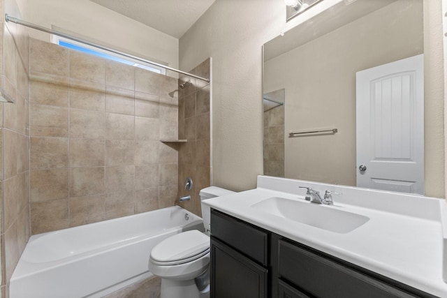 full bathroom featuring toilet, vanity, and tiled shower / bath