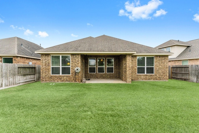 back of property with a patio area and a lawn