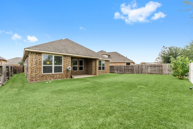 back of property with a lawn and a patio area