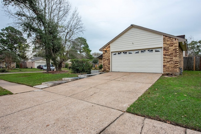 view of side of property with a garage and a lawn