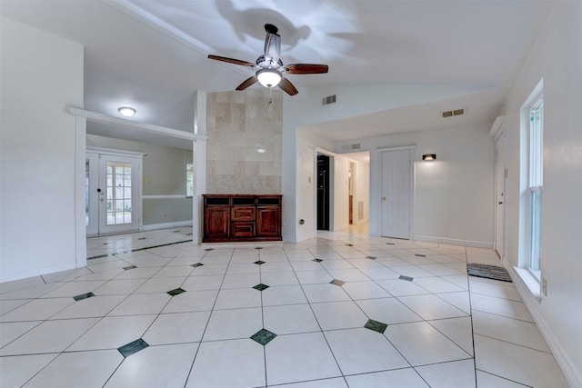 unfurnished living room featuring ceiling fan, light tile patterned floors, and lofted ceiling