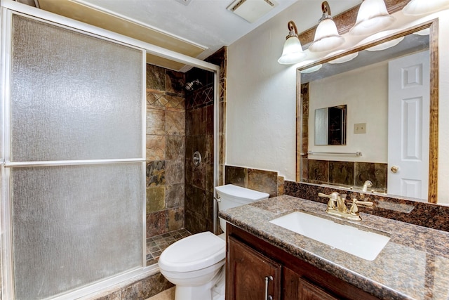 bathroom featuring vanity, toilet, and walk in shower