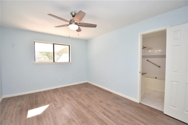 unfurnished bedroom featuring ensuite bathroom, ceiling fan, and light hardwood / wood-style floors