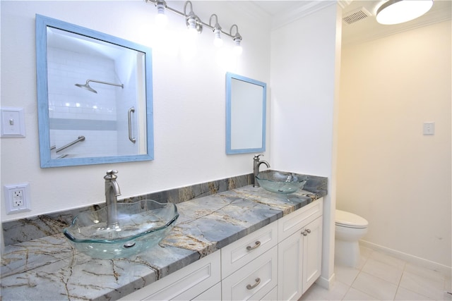 bathroom with tile patterned floors, vanity, ornamental molding, and toilet