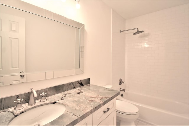 full bathroom with toilet, vanity, and tiled shower / bath