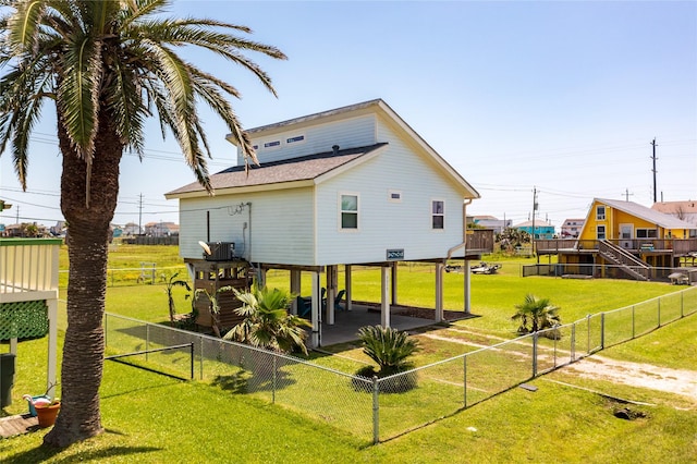 rear view of house with a yard and a patio