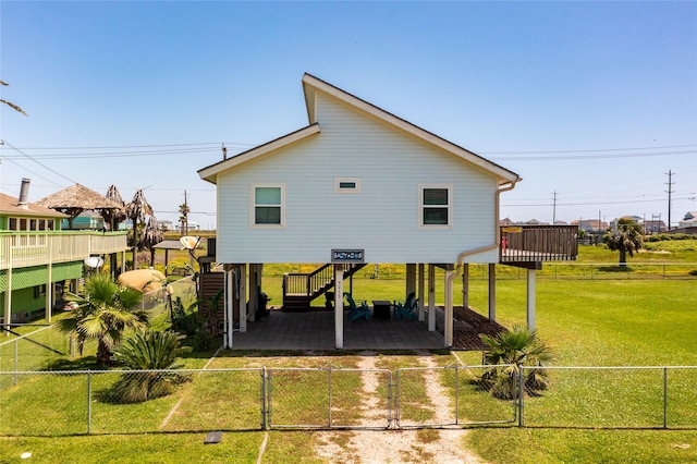 rear view of house with a lawn, a patio area, and a wooden deck