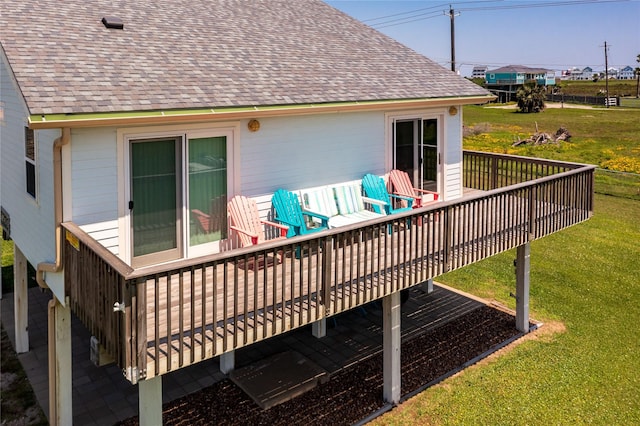 wooden deck featuring a lawn