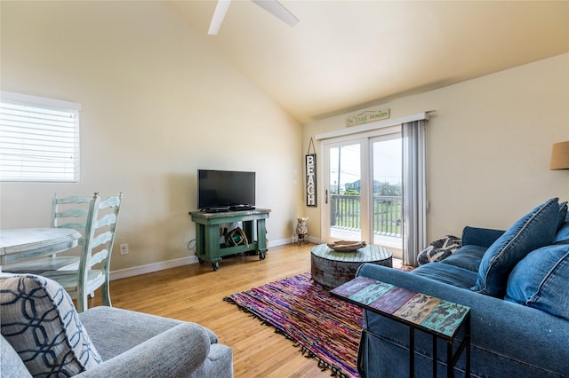 living room with ceiling fan, wood-type flooring, and high vaulted ceiling