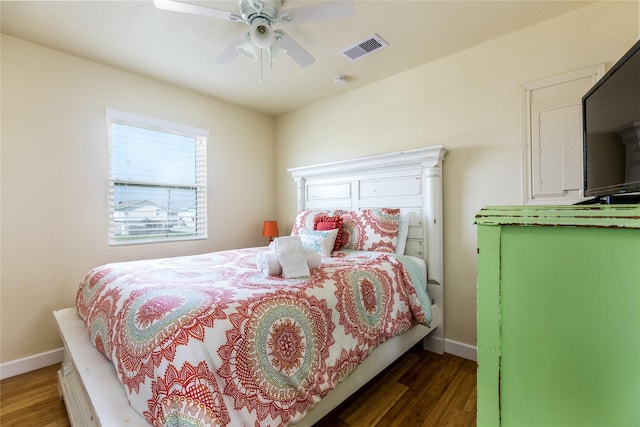 bedroom with dark hardwood / wood-style floors and ceiling fan