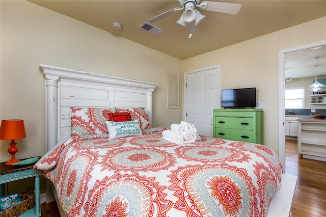 bedroom featuring hardwood / wood-style flooring and ceiling fan