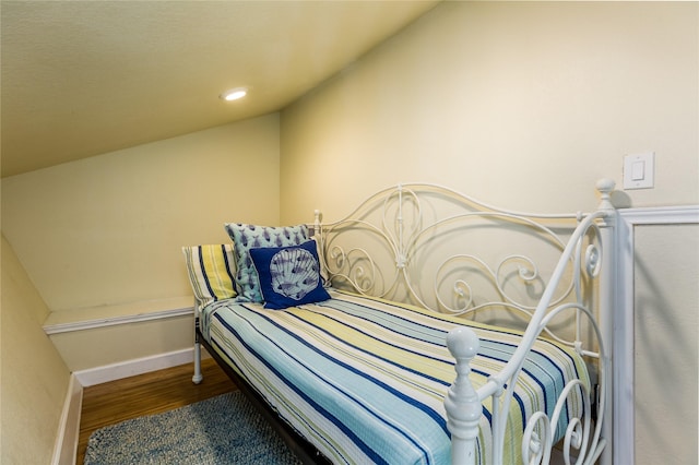 bedroom featuring wood-type flooring and lofted ceiling