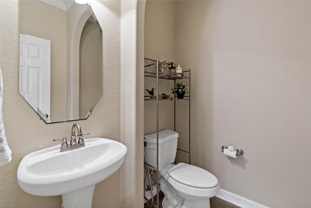 bathroom featuring sink and toilet