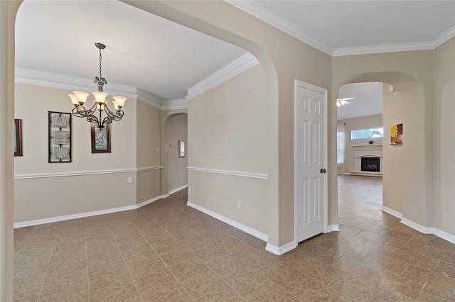 spare room with ceiling fan with notable chandelier and crown molding