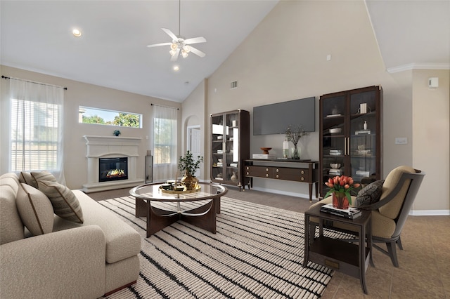 living room with ceiling fan and high vaulted ceiling