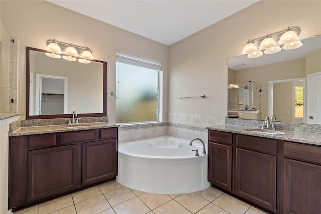 bathroom with tile patterned flooring, plenty of natural light, and vanity