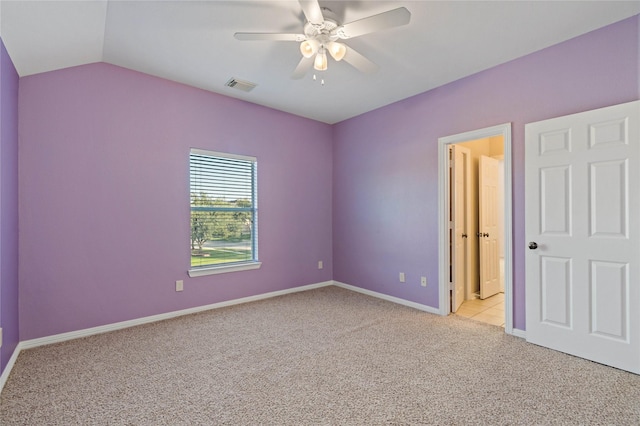 unfurnished bedroom with ceiling fan, light carpet, and lofted ceiling