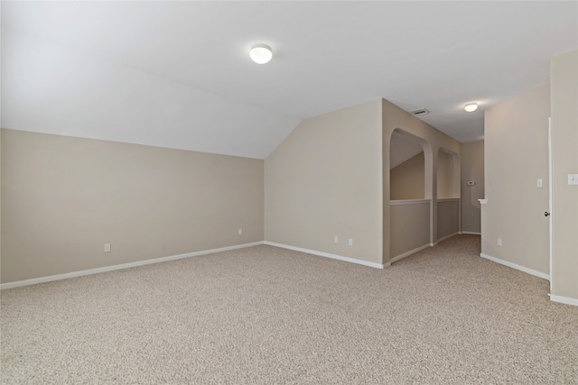 additional living space with carpet flooring and lofted ceiling