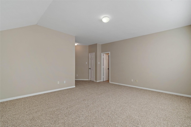 unfurnished room with carpet floors and lofted ceiling