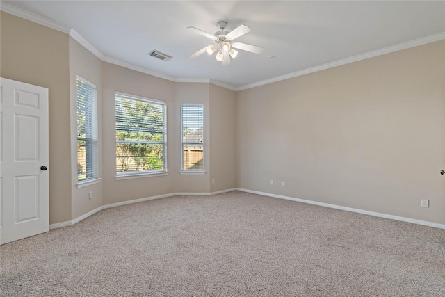 carpeted empty room featuring ceiling fan and ornamental molding