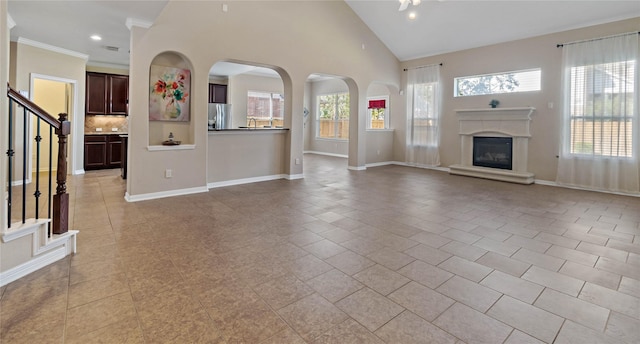 unfurnished living room featuring light tile patterned floors and a wealth of natural light