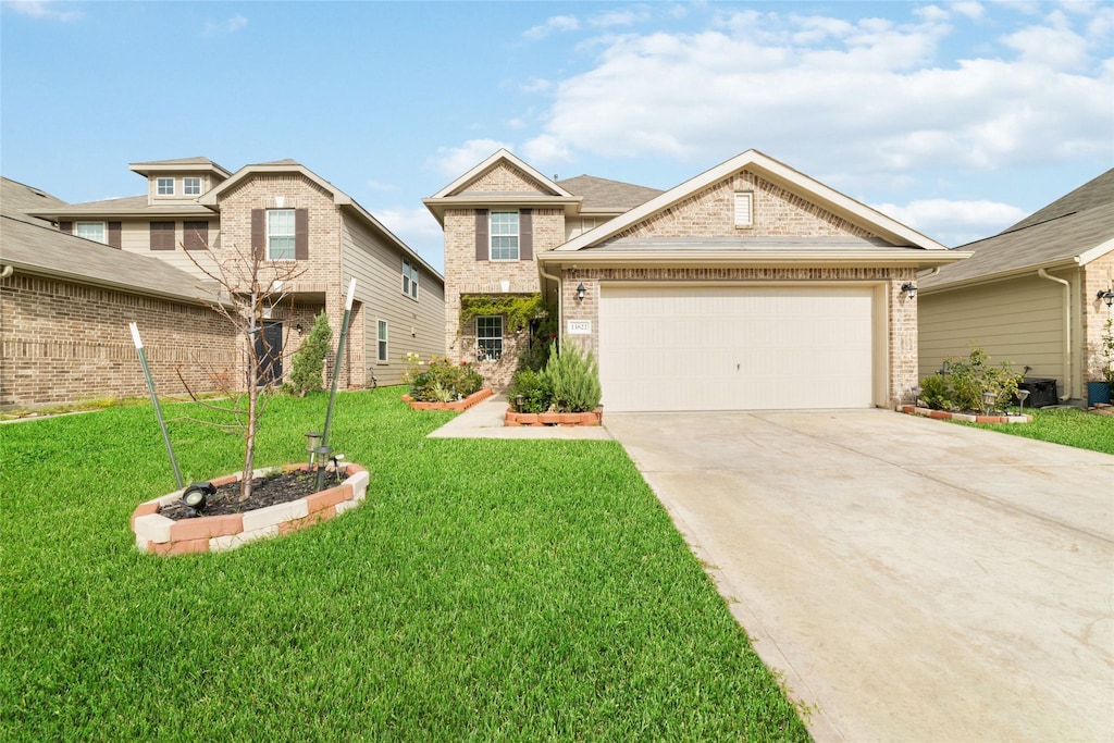 view of front of house with a garage and a front yard