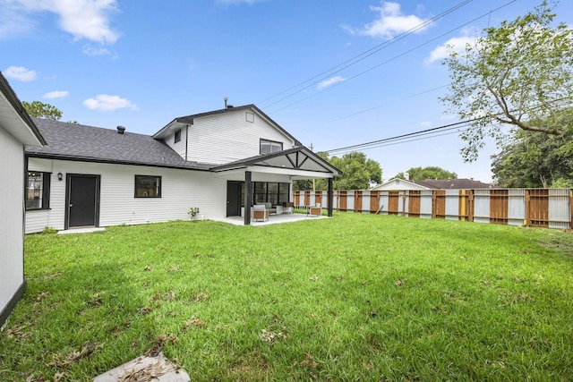 rear view of house with a patio area and a lawn