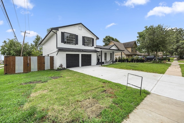 view of front of home with a front yard and a garage