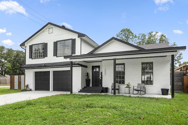 view of front facade featuring a porch, a garage, and a front lawn