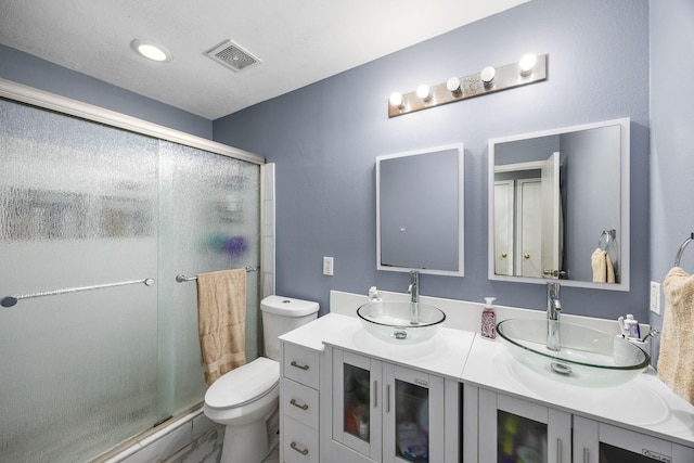 bathroom with vanity, toilet, and walk in shower