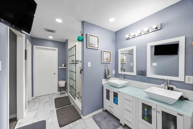 bathroom featuring vanity and a shower with door