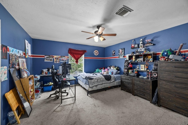 carpeted bedroom featuring a textured ceiling and ceiling fan